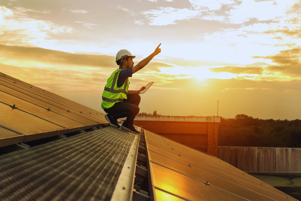 a man in a safety vest on a roof